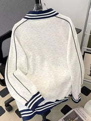 Gray plus-size zip-up sweatshirt with navy blue striped collar and cuffs.