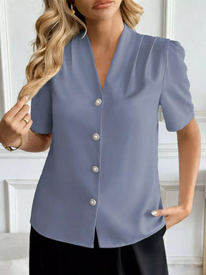 Blue V-neck short sleeve shirt with pearl buttons and subtle shoulder pleats.