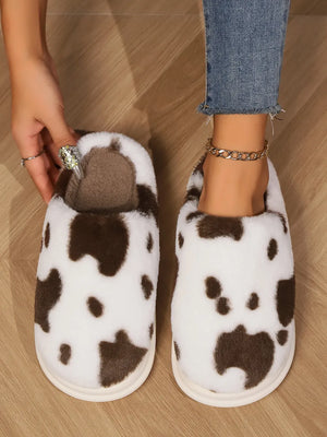 Cow print faux fur house slides in white and brown, with plush lining.