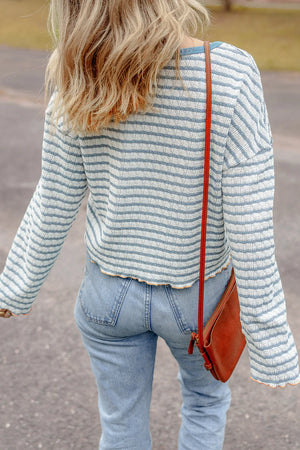 Textured stripe henley sweater in dusty blue with a relaxed fit and bell sleeves.