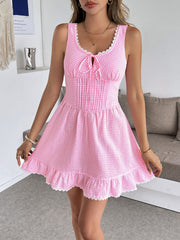 Pink gingham mini dress with sweetheart neckline, lace trim, and ruffled hem.