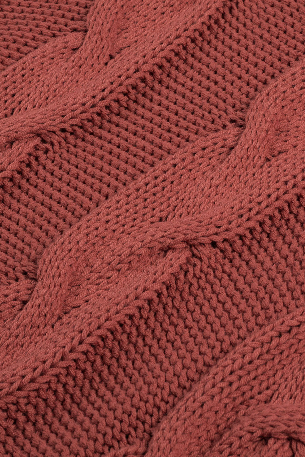 Cable knit turtleneck sweater in rust acrylic with a relaxed fit.