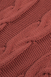Cable knit turtleneck sweater in rust acrylic with a relaxed fit.