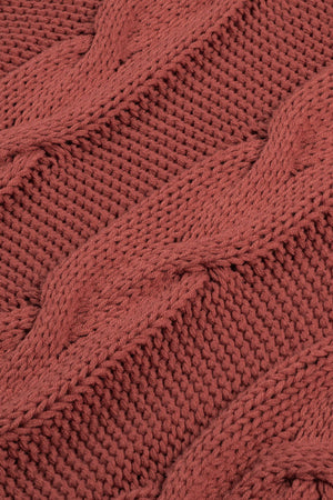 Cable knit turtleneck sweater in rust acrylic with a relaxed fit.