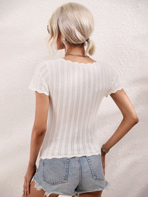 White knit top with scalloped square neckline and eyelet pattern.