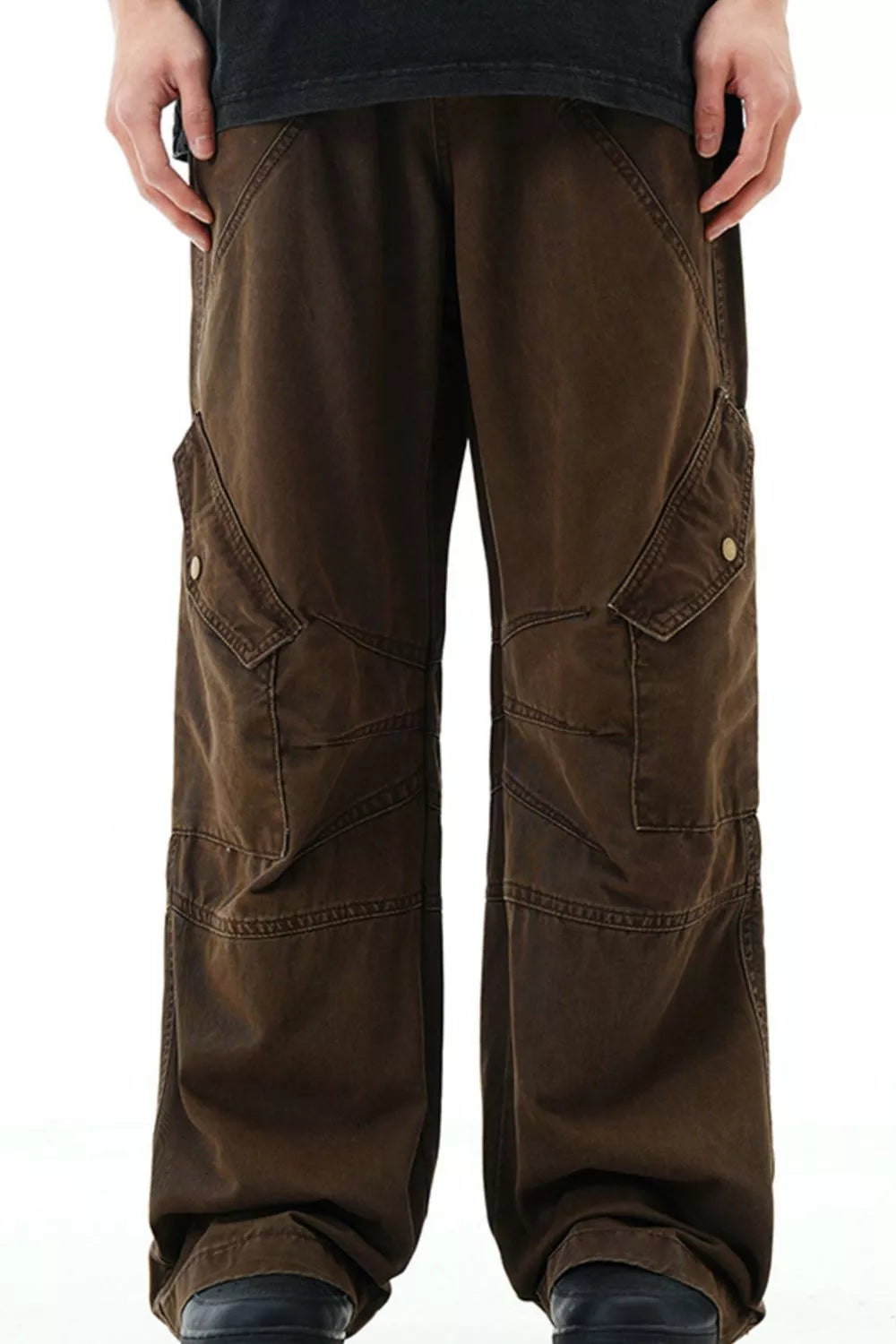 Brown cargo pants with snap pockets and detailed stitching.