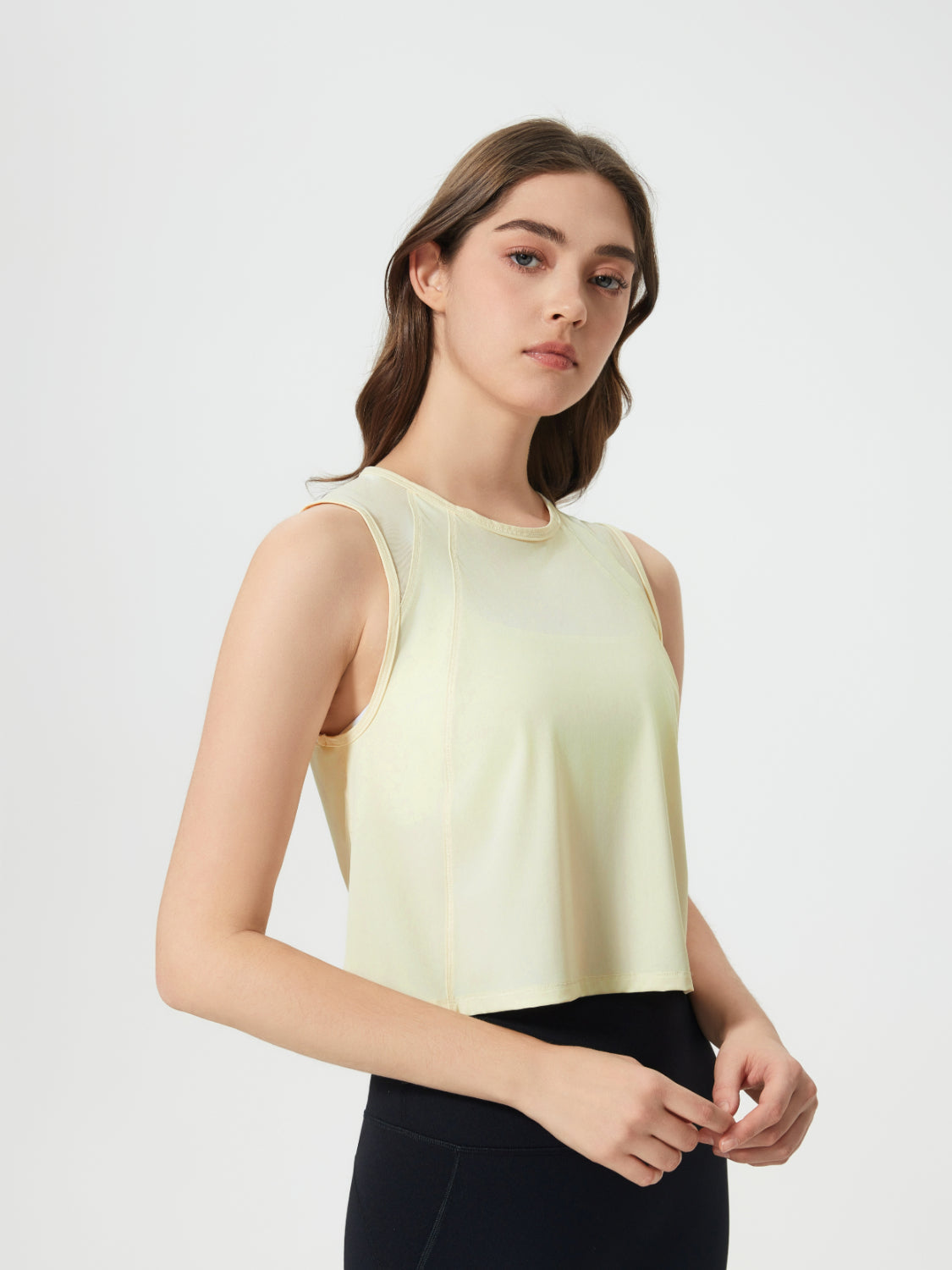 Pastel Yellow mesh-inset back cropped active tank top with crew neck and sleeveless design.
