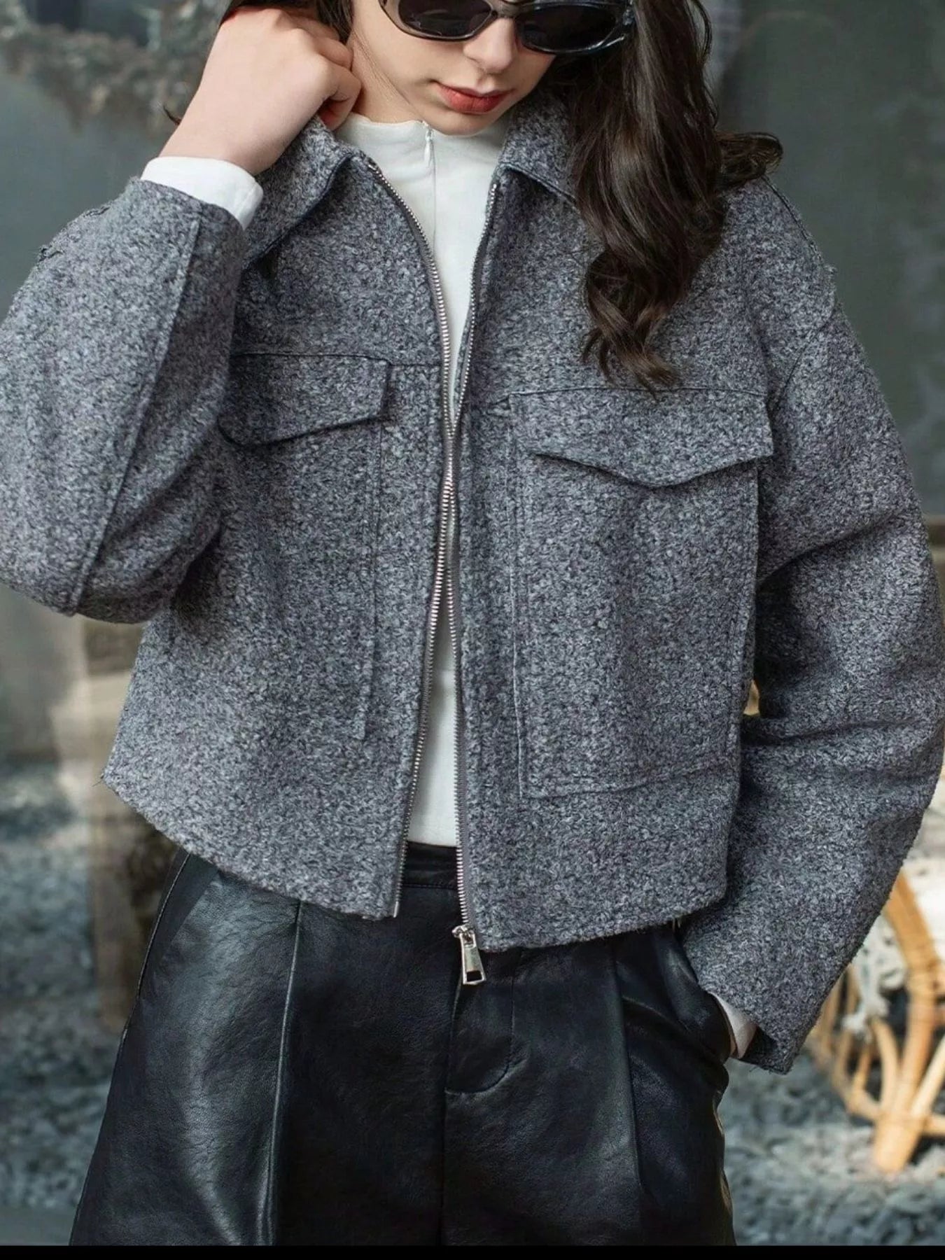 Gray cropped zip-up jacket with two chest pockets and a textured finish.