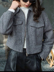 Gray cropped zip-up jacket with two chest pockets and a textured finish.