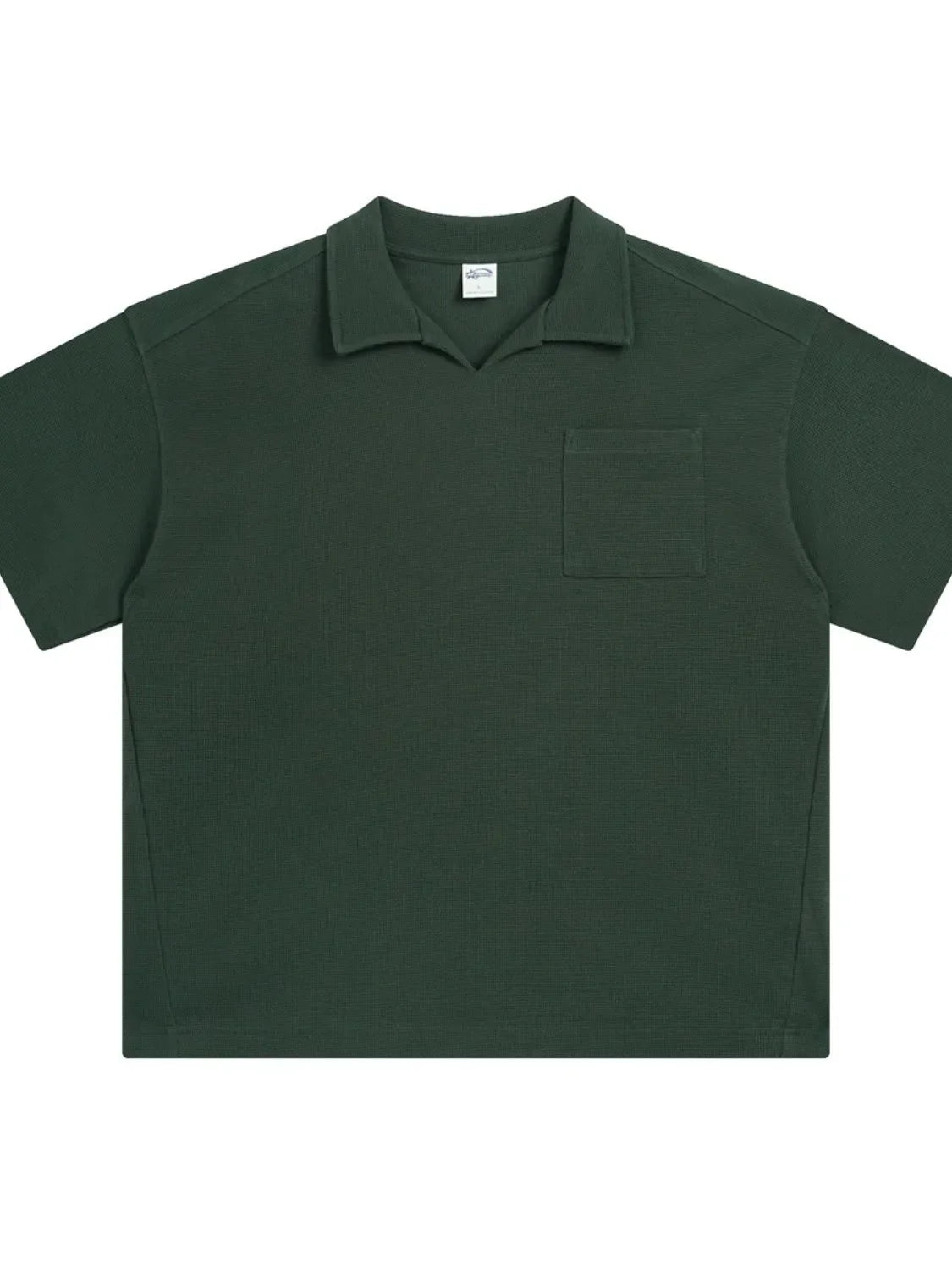 Dark green boxy knit polo shirt with a patch pocket and spread collar.