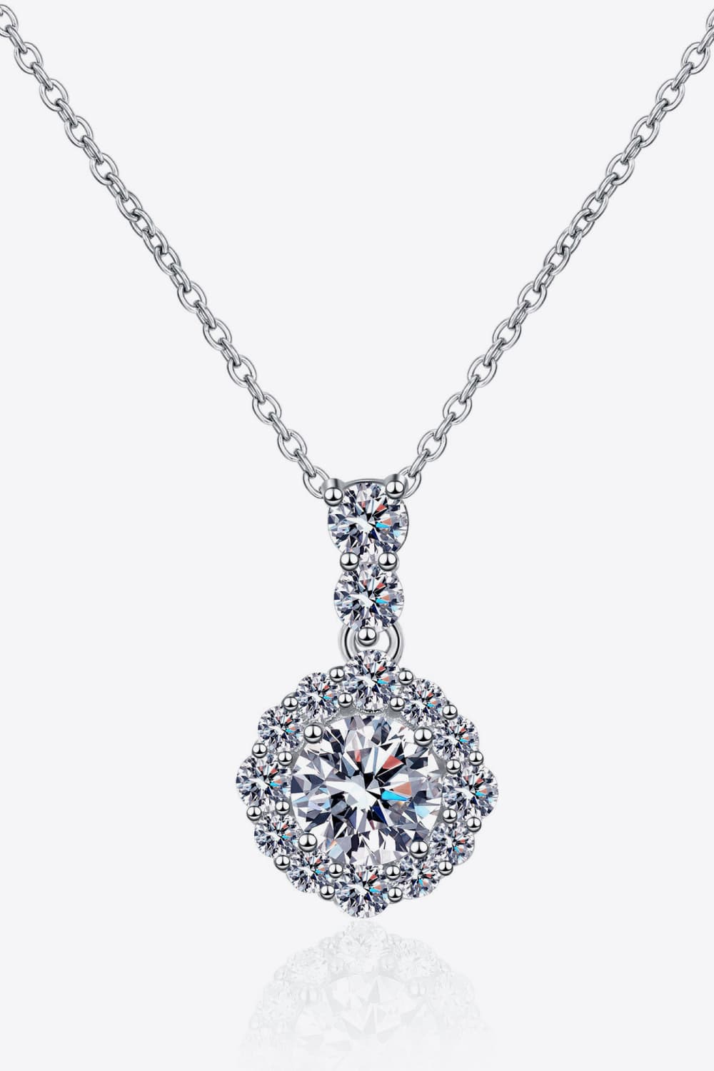 Silver moissanite pendant necklace in sterling silver with a halo of small stones.