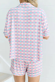 Pastel checkered pajama set with collared short sleeve top and shorts.