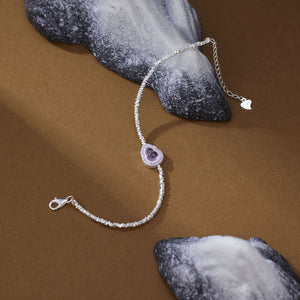 Delicate gourd charm bracelet with purple crystal and silver beads.