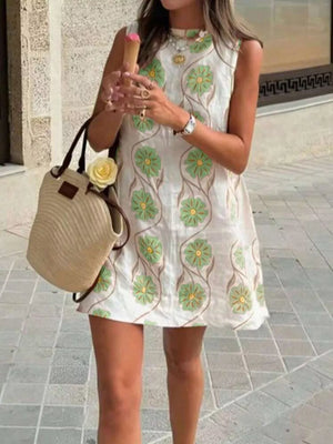 Delicate floral mini dress with high neckline in white with green floral embroidery.