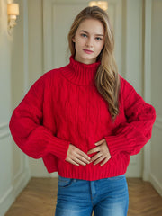 Oversized red cable knit turtleneck sweater with balloon sleeves.