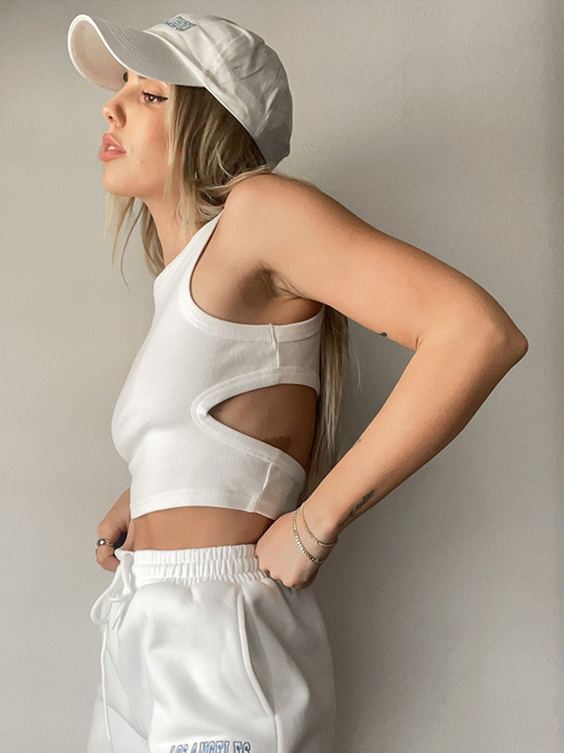 White ribbed crop top with cutout detail and racerback.