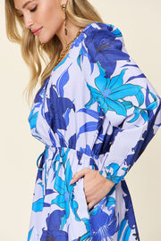 Blue floral wrap romper with long sleeves and cinched waist