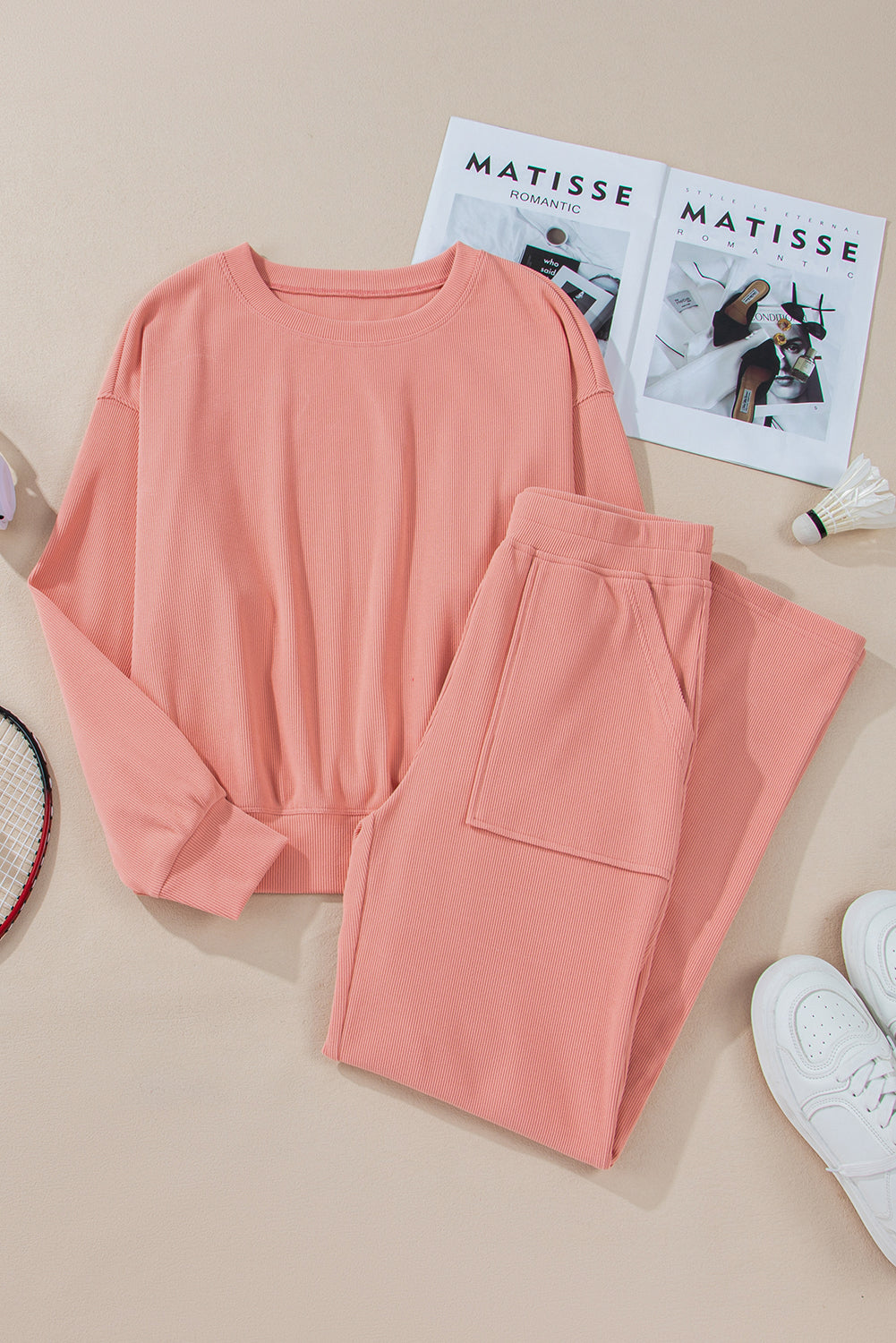 Pink corduroy lounge set with crewneck sweatshirt and wide-leg pants with pockets.