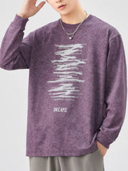 Purple oversized long-sleeve tee with graphic text print and "DREAMS" graphic.