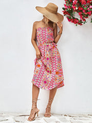 Printed bandeau midi dress with belted waist and asymmetric hem in pink and orange.