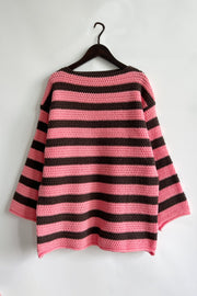 Pink and brown striped boat neck knit sweater with crochet texture.