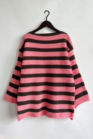 Pink and brown striped boat neck knit sweater with crochet texture.