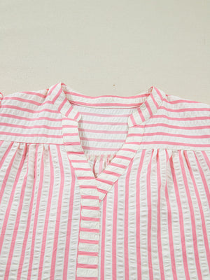 Pink and white striped seersucker blouse with V-neck and gathered yoke.
