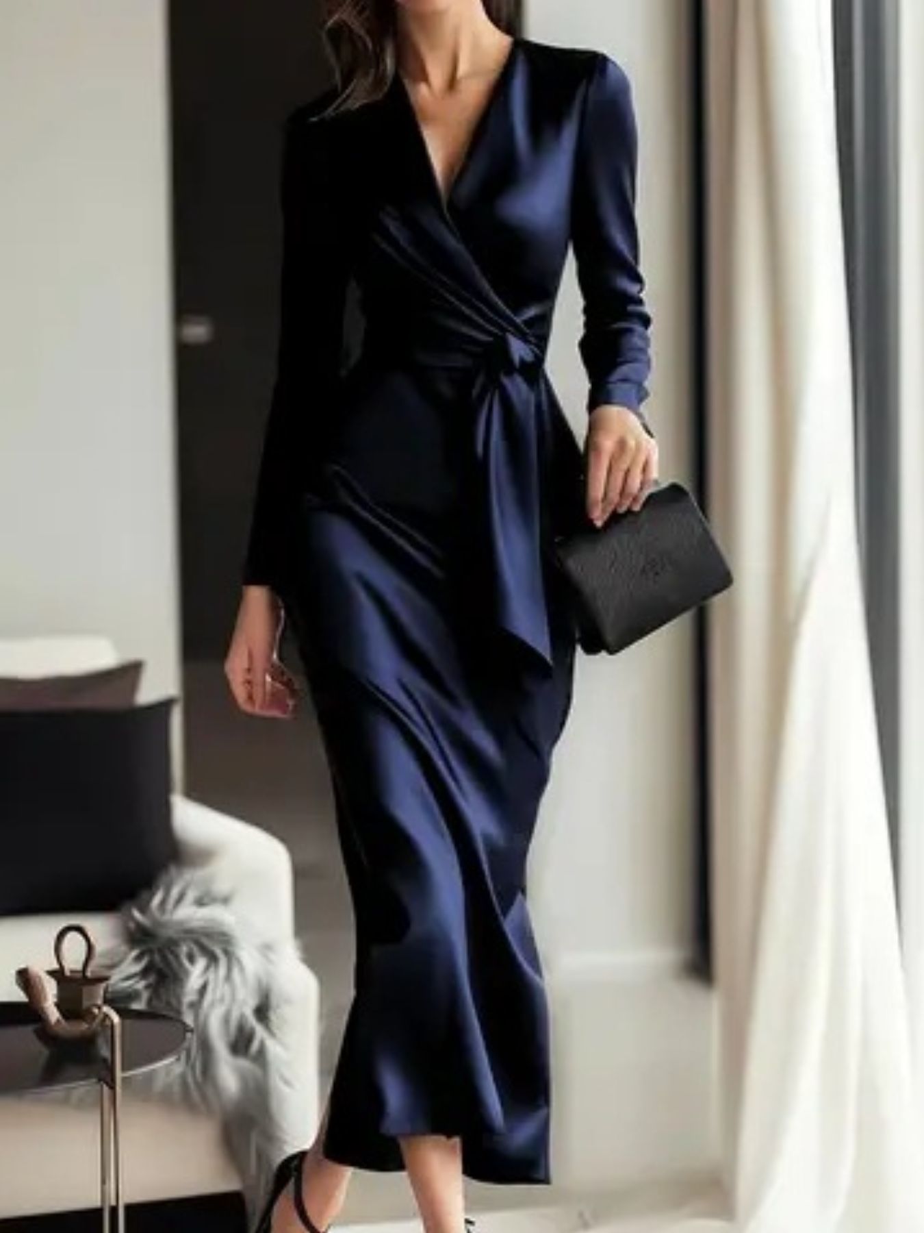 Luxurious satin tie-waist dress in dark blue with V-neck and long sleeves.