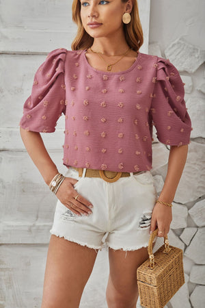 Dusty Pink textured puff-sleeve blouse with pom-pom details and round neckline.