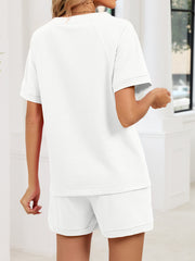 White two-piece loungewear set with a short-sleeve top and comfortable shorts.