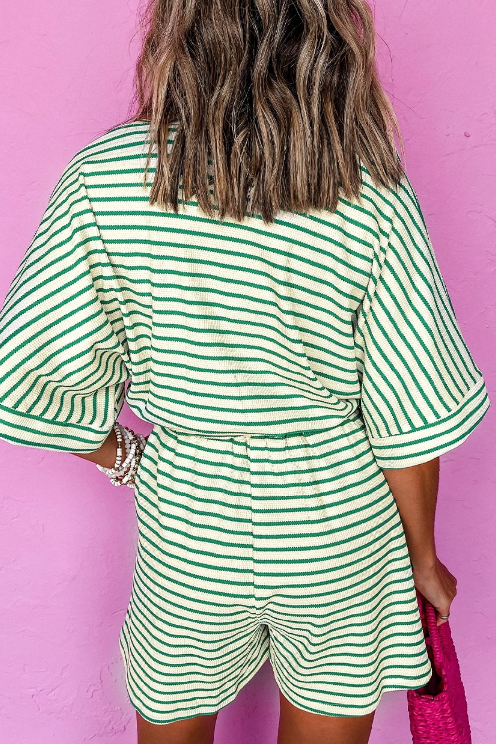 Green striped resort shirt romper with tie, short sleeves, elastic waist, and shorts.