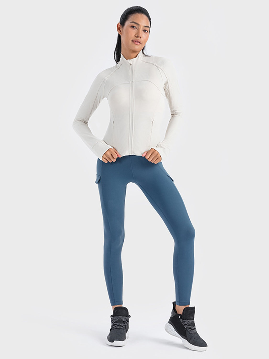 White ribbed performance zip-up jacket with thumbholes and mock neck