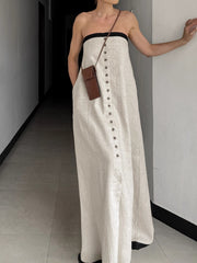 Button front tube maxi dress in beige cotton blend with black trim.