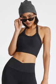 Black ribbed halter crop top with a racerback detail.