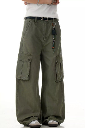 Olive green wide-leg cargo pants with multiple pockets and a beaded keychain accessory.
