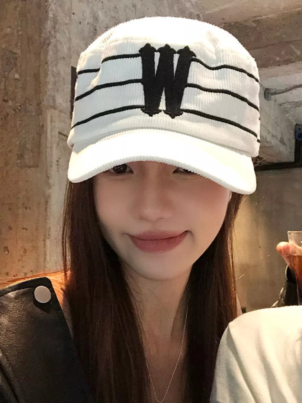 White cotton baseball cap with black stripes and embroidered W