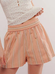 Peach striped shorts with elastic waistband and pockets.