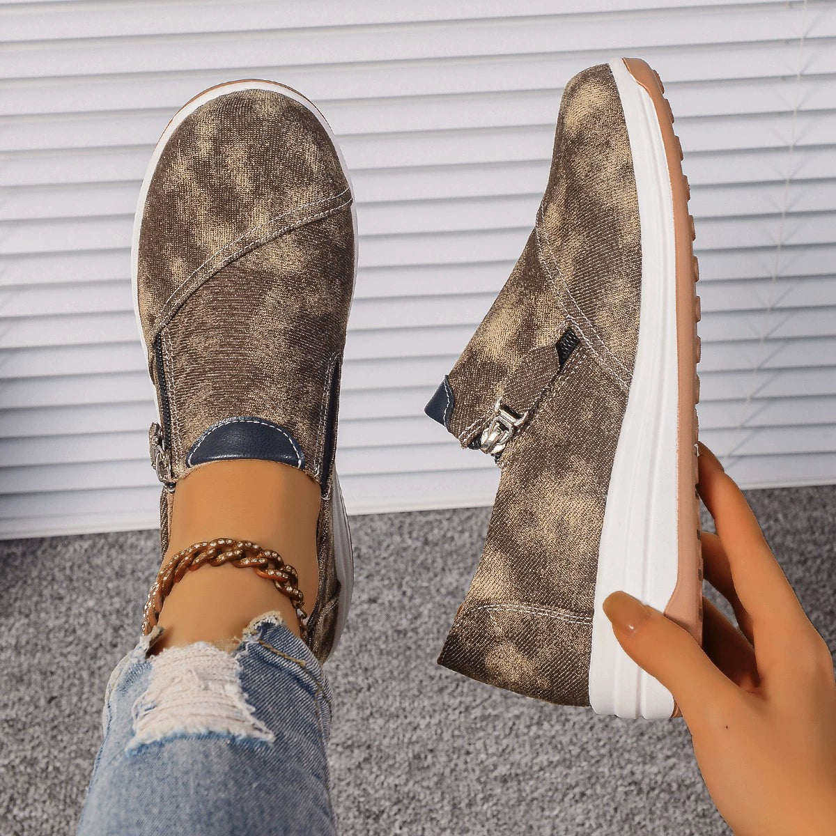 Brown casual slip-on sneakers with a distressed pattern and chunky sole.