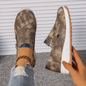 Brown casual slip-on sneakers with a distressed pattern and chunky sole.