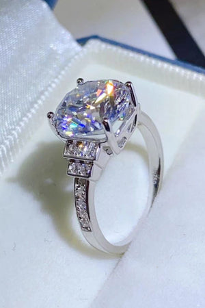 Sterling silver ring with radiant cut center stone and diamond halo band.