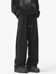 Men's black loose fit drawstring pants with a comfortable cotton blend fabric.