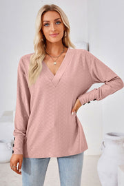 Blush pink textured v-neck long sleeve blouse with button cuffs