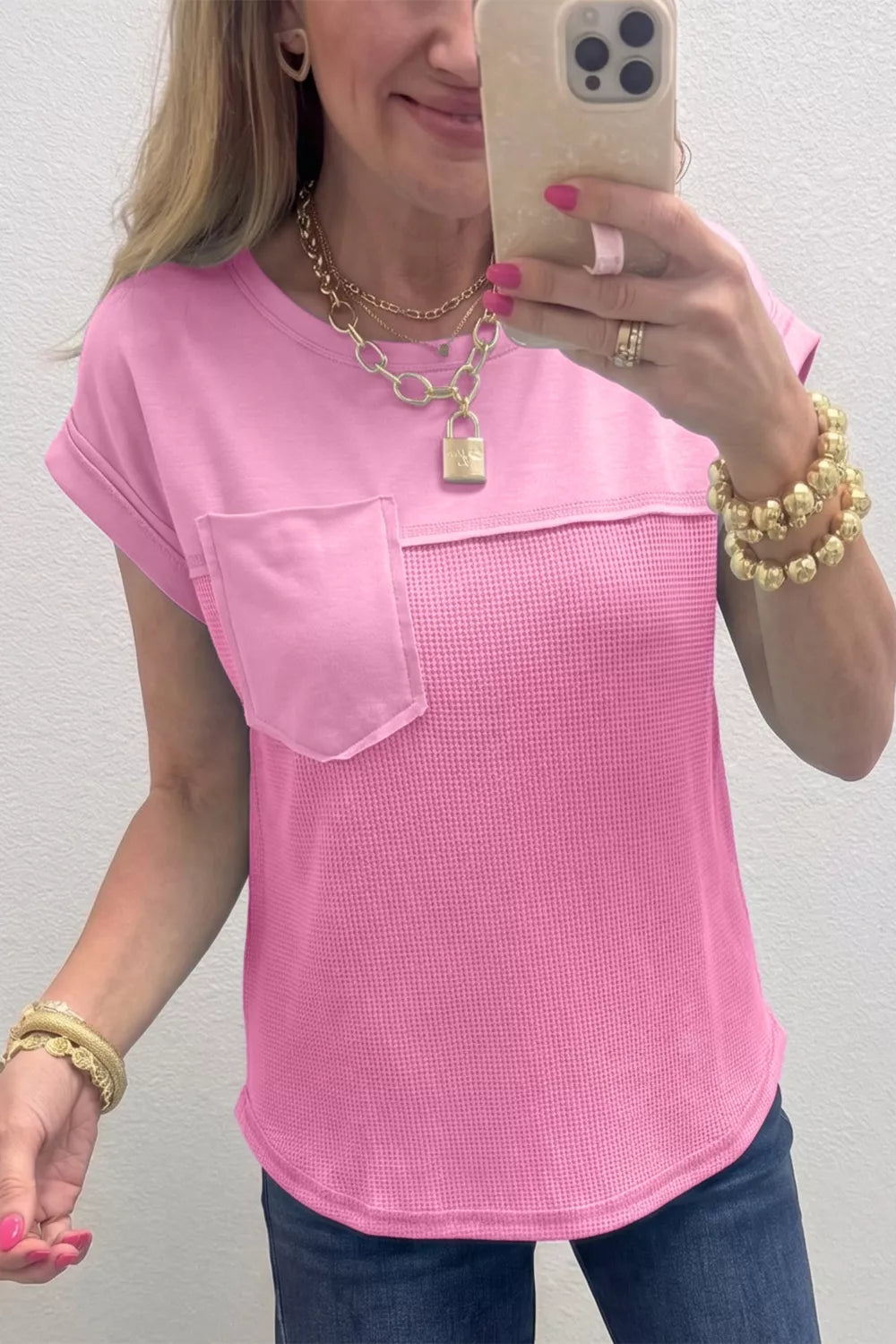 Pink waffled seam pocketed t-shirt with short sleeves and a crew neck.