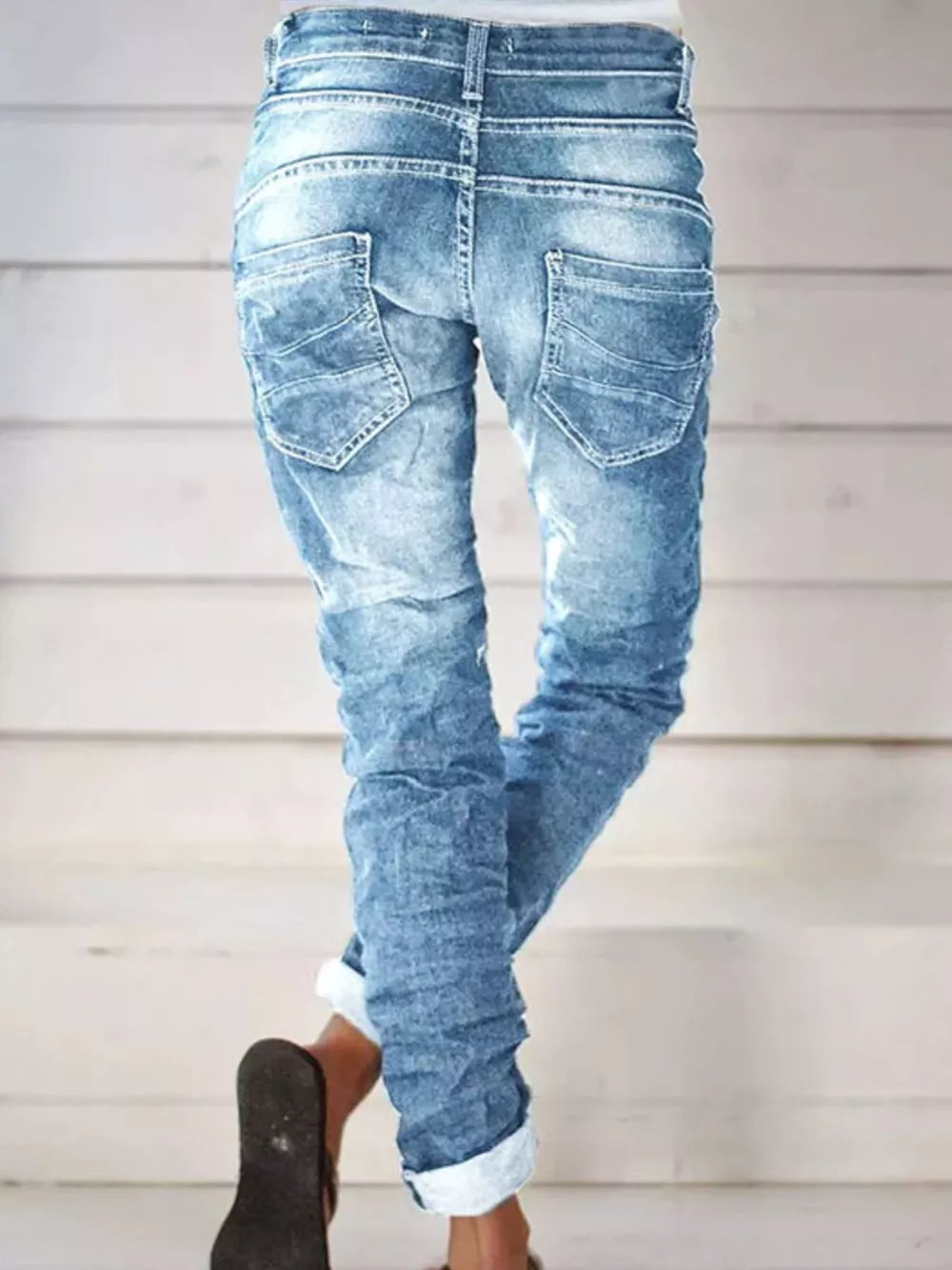 Light blue cuffed jeans with button fly and distressed details