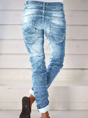 Light blue cuffed jeans with button fly and distressed details