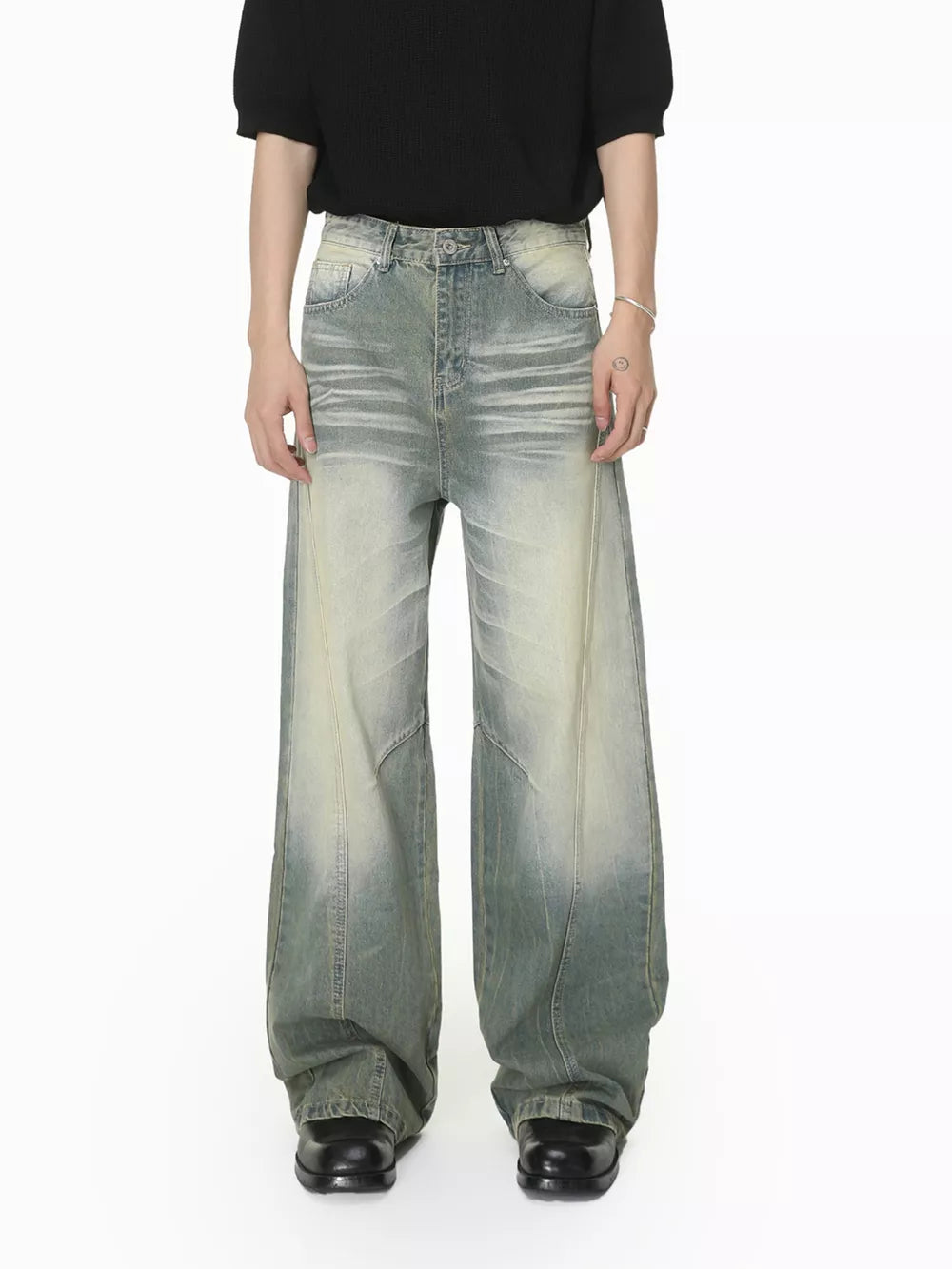 Men's light wash wide leg jeans with a relaxed fit and faded details.