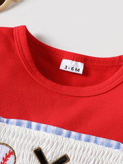 Red baseball graphic tee with smocked white fabric and blue gingham trim.