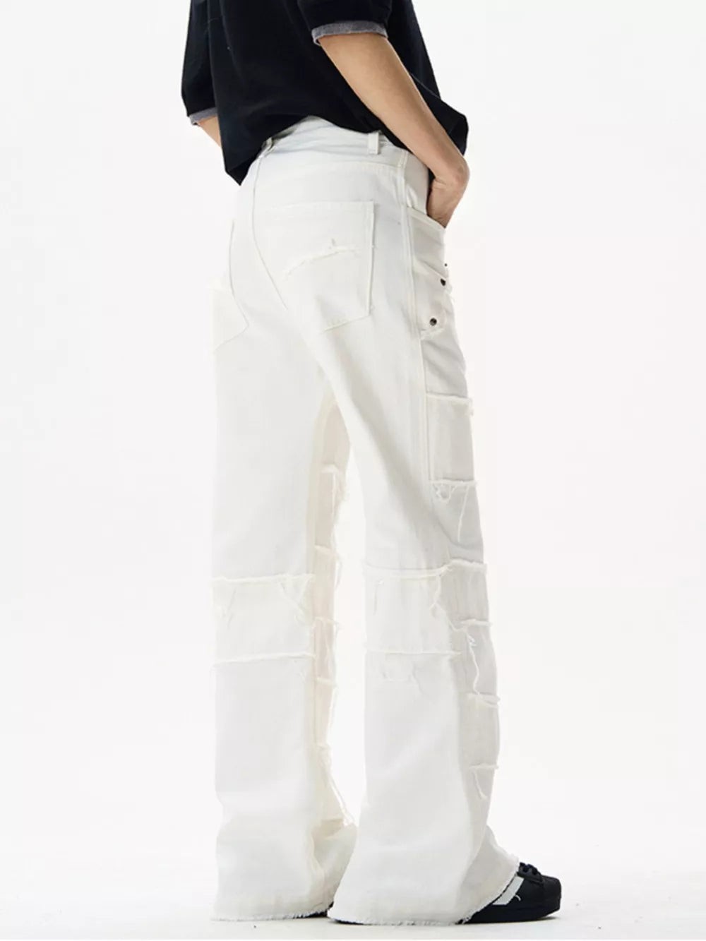 White stretch flare jeans with frayed hem details and distressed patches.
