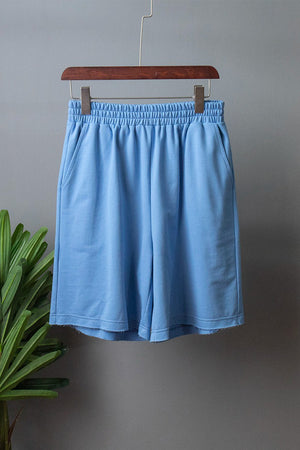 Pastel blue relaxed fit shorts with elastic waist and raw hem detail