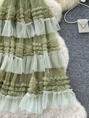 Green tiered tulle skirt with abundant ruffles and sheer overlay.